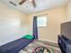 Small bedroom with a laminate floor, window, and bed - ideal for a  at 12181 Se 87Th Ct, Belleview, FL 34420