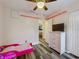 Bedroom with pale pink decor, laminate floor, closet, and bed at 12181 Se 87Th Ct, Belleview, FL 34420
