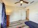 Cozy bedroom featuring laminate floor, closet, and a bed by the closet at 12181 Se 87Th Ct, Belleview, FL 34420