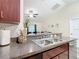 Close up of the kitchen, featuring stone countertops, stainless steel sink, and modern faucet at 12181 Se 87Th Ct, Belleview, FL 34420