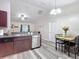 Well-lit kitchen features stainless appliances, stone countertops, and dining area at 12181 Se 87Th Ct, Belleview, FL 34420
