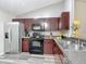 Modern kitchen featuring dark wood cabinets, stainless steel appliances, and stone countertops at 12181 Se 87Th Ct, Belleview, FL 34420