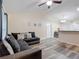 Spacious open living area featuring hard surface flooring, a comfortable sofa, and view into the dining area and kitchen at 12181 Se 87Th Ct, Belleview, FL 34420