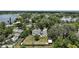 Aerial shot showcases the home's location amidst mature trees and tranquil lakes in a peaceful neighborhood at 126 E Beach St, Groveland, FL 34736