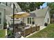Backyard patio with modern outdoor furniture and sliding glass doors at 126 E Beach St, Groveland, FL 34736