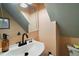 Compact bathroom featuring a pedestal sink, black faucet, and a built-in mirror at 126 E Beach St, Groveland, FL 34736
