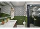 Stylish bathroom features patterned wallpaper, modern fixtures, and glass door shower at 126 E Beach St, Groveland, FL 34736