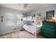 Bright bedroom featuring a bunk bed, hardwood floors, and natural light from windows at 126 E Beach St, Groveland, FL 34736