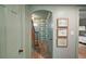 Charming entryway with archway, wood floors, stairs, and artwork on the wall at 126 E Beach St, Groveland, FL 34736