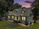 Charming two-story home with dormer windows, manicured lawn, and inviting front entrance at dusk at 126 E Beach St, Groveland, FL 34736