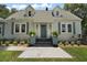 Charming home with a blue front door and decorative plants at 126 E Beach St, Groveland, FL 34736