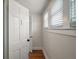 Bright hallway with hardwood floors, white walls, and two doors leading to other rooms at 126 E Beach St, Groveland, FL 34736