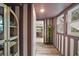 Hallway featuring unique striped walls, hardwood floors, and hanging plant accent at 126 E Beach St, Groveland, FL 34736