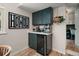 Kitchen nook with dark green cabinets, wine cooler, and quartz countertop, complete with coffee appliances at 126 E Beach St, Groveland, FL 34736