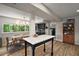 Open-concept kitchen featuring a dining area with a large window and modern light fixture at 126 E Beach St, Groveland, FL 34736