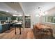 Modern kitchen featuring dark green cabinets, stainless steel appliances, and a dining area at 126 E Beach St, Groveland, FL 34736