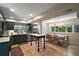 Open concept kitchen and dining area with modern lighting and stainless steel appliances at 126 E Beach St, Groveland, FL 34736