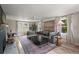 Bright and spacious living room featuring a comfortable sofa, large windows, and stylish decor at 126 E Beach St, Groveland, FL 34736
