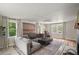 Sunlit living room with a spacious sectional sofa, natural light, and stylish decor for relaxation at 126 E Beach St, Groveland, FL 34736