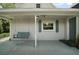 Covered porch featuring a relaxing swing at 126 E Beach St, Groveland, FL 34736