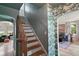 Staircase featuring hardwood steps and handrail with patterned wallpaper accenting the walls at 126 E Beach St, Groveland, FL 34736