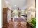 Spacious foyer with hardwood floors, elegant lighting, and open access to living and dining areas at 13 Hickory Head Hammock, The Villages, FL 32159