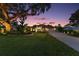 Inviting single-story home featuring lush landscaping, a spacious driveway, and a well-manicured lawn at 13 Hickory Head Hammock, The Villages, FL 32159