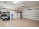 Spacious garage with ample storage cabinets, overhead door, and an organized layout for vehicles and tools at 13 Hickory Head Hammock, The Villages, FL 32159