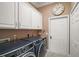 Functional laundry room featuring modern appliances, ample storage, and a clean and organized space at 13 Hickory Head Hammock, The Villages, FL 32159