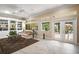 Elegant living room featuring built-in bookshelves, natural light, and seamless access to outdoor patio at 13 Hickory Head Hammock, The Villages, FL 32159