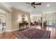 Open-concept living area with hardwood floors, natural lighting, and stylish furnishings perfect for entertaining at 13 Hickory Head Hammock, The Villages, FL 32159