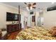 Spacious main bedroom featuring hardwood floors, a ceiling fan, and comfortable furnishings at 13 Hickory Head Hammock, The Villages, FL 32159