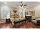 Serene main bedroom with hardwood floors, natural light, and stylish décor creating a relaxing retreat at 13 Hickory Head Hammock, The Villages, FL 32159