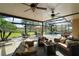 Covered outdoor living space with a screened pool and a scenic backyard at 13 Hickory Head Hammock, The Villages, FL 32159