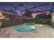 A screened pool with fountain features and a beautiful dusk sky view at 13 Hickory Head Hammock, The Villages, FL 32159