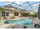 A screened pool with outdoor seating area and beautiful backyard views at 13 Hickory Head Hammock, The Villages, FL 32159