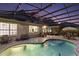 A screened pool with fountain features and outdoor seating area at 13 Hickory Head Hammock, The Villages, FL 32159