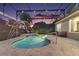 Inviting pool area with a screened enclosure, palm tree, waterfall feature, and ample space for relaxation at 13 Hickory Head Hammock, The Villages, FL 32159