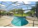 A screened pool with fountain features and a scenic backyard at 13 Hickory Head Hammock, The Villages, FL 32159