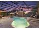 A screened pool with fountain features and an umbrella table with chairs at 13 Hickory Head Hammock, The Villages, FL 32159