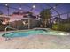 Relaxing screened-in pool area with a rock waterfall feature, a seating area and manicured landscaping at 13 Hickory Head Hammock, The Villages, FL 32159
