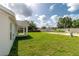 Large backyard with green grass and a view of neighboring fences and properties at 13334 Sw 107Th St, Dunnellon, FL 34432