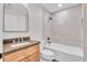 Well-lit bathroom with tiled shower-tub combination and modern vanity with a dark countertop at 13334 Sw 107Th St, Dunnellon, FL 34432