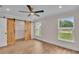 Bright bedroom with windows and sliding barn door closet, offering a modern aesthetic at 13334 Sw 107Th St, Dunnellon, FL 34432