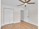 Bedroom with ceiling fan, closet, door and wood-look flooring at 13334 Sw 107Th St, Dunnellon, FL 34432