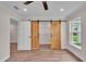 Bedroom with adjacent closet and barn door, offering a modern aesthetic at 13334 Sw 107Th St, Dunnellon, FL 34432