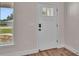 Bright foyer showcasing a modern white front door with glass insert and digital lock at 13334 Sw 107Th St, Dunnellon, FL 34432