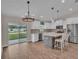 Well-lit kitchen offering stainless steel appliances, an island with barstool seating, and backyard views at 13334 Sw 107Th St, Dunnellon, FL 34432