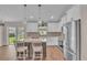 Bright kitchen showcasing white cabinets, stainless steel appliances, and an island with seating at 13334 Sw 107Th St, Dunnellon, FL 34432