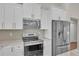 Modern kitchen featuring stainless steel appliances, white cabinets, and stylish backsplash at 13334 Sw 107Th St, Dunnellon, FL 34432